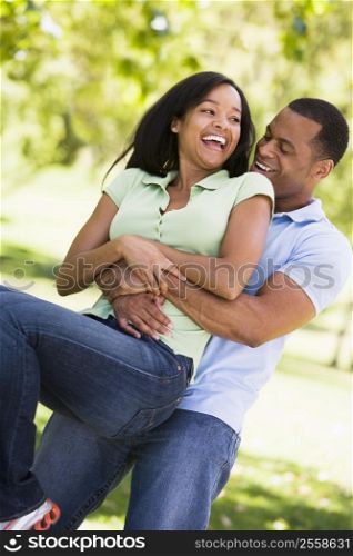 Couple being playful outdoors smiling