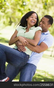 Couple being playful outdoors smiling