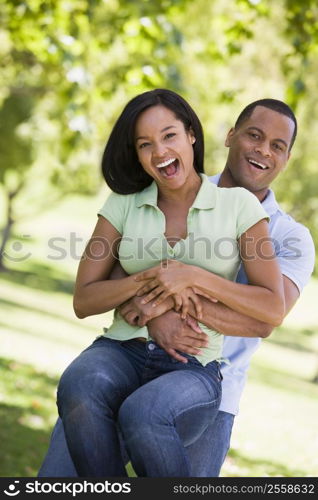 Couple being playful outdoors smiling