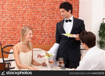 Couple being served their meal