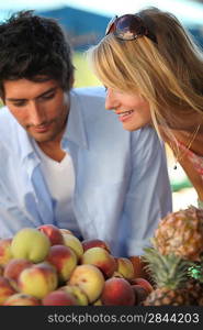 Couple buying fruit at a local market