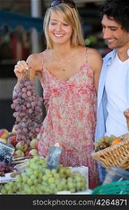 Couple buying fruit at the market