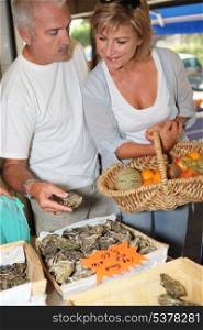 Couple buying oysters
