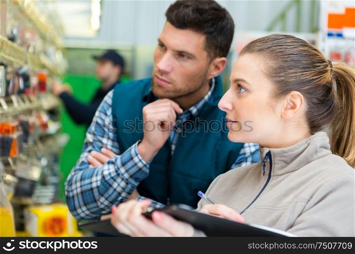 couple buying tools for house decoration in supplies store