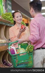 Couple buying vegetables in supermarket, Beijing