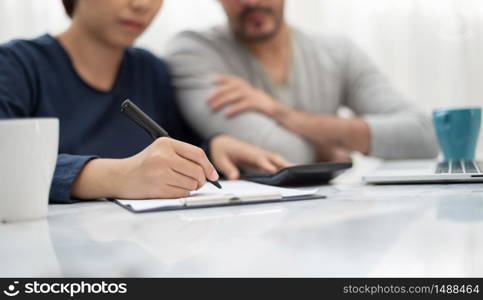 Couple calculating her Debt. Monthly expense.