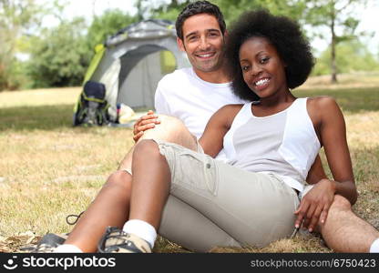Couple camping in a grassy field