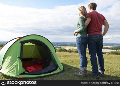 Couple Camping In Countryside Standing By Tent
