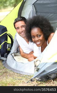 Couple camping in tent