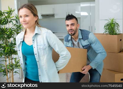 couple carrying heavy box