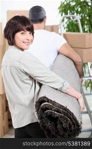 Couple carrying rug
