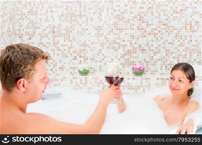 couple celebrates anniversary in the bath with foam