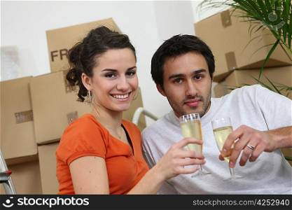 Couple celebrating purchase of first house together