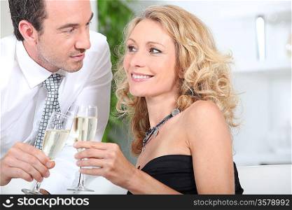 Couple celebrating with a glass of champagne