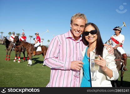 Couple Celebrating with Champagne at a Polo Match