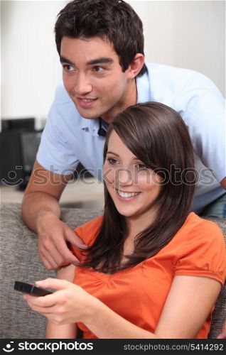 Couple changing television channel