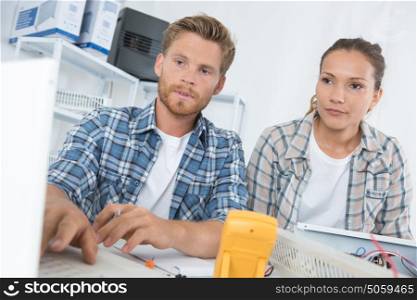 couple checking computer at home