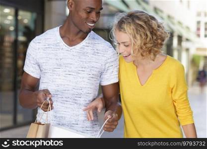 couple checking eachother shopping bags