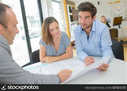 couple checking paperwork at an agency