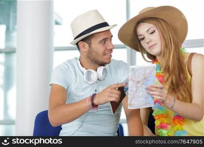 couple checking the map while in the airport