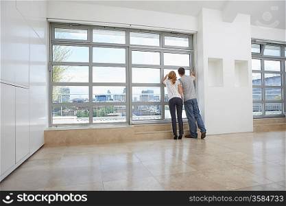 Couple Checking View From New Apartment