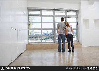 Couple Checking View From New Apartment