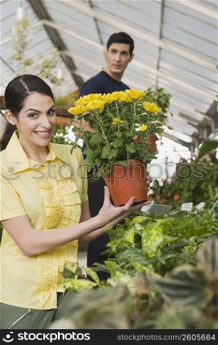 Couple choosing potted plants in a garden center