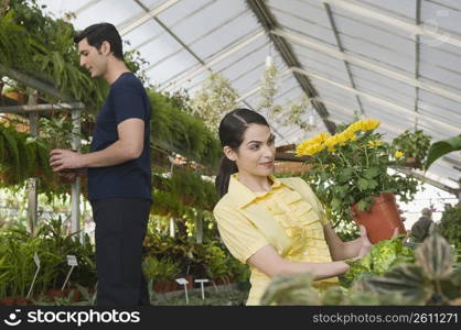 Couple choosing potted plants in a garden center