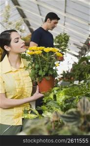Couple choosing potted plants in a garden center