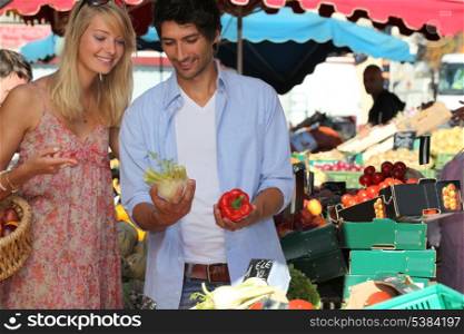 Couple choosing vegetables at the market