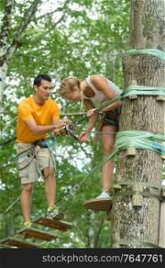 couple climbing an adventure park