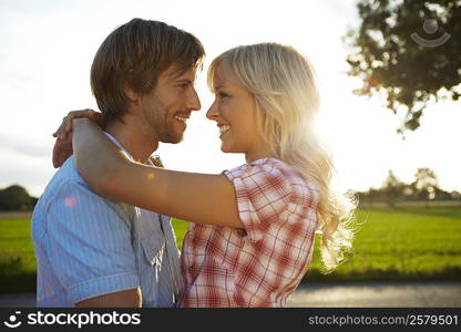 Couple close/hugging during sunset