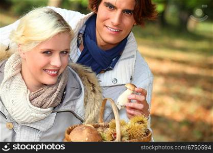 Couple collecting chestnuts