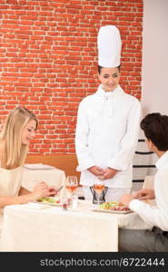 Couple complimenting the chef on her cooking