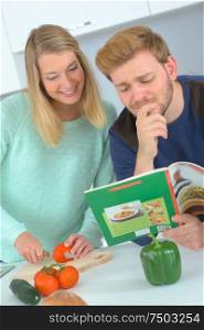 couple consulting the recipe book for some ideas