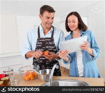 Couple cooking fruit jam at home