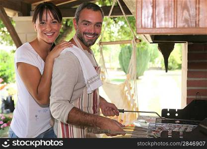 Couple cooking on a barbecue