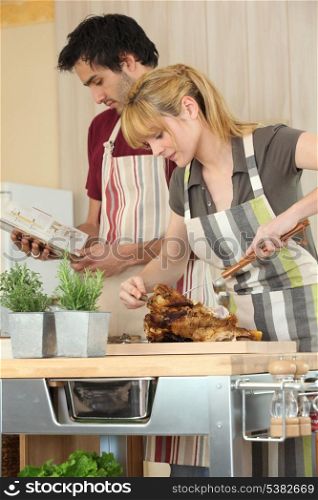 Couple cooking roast chicken