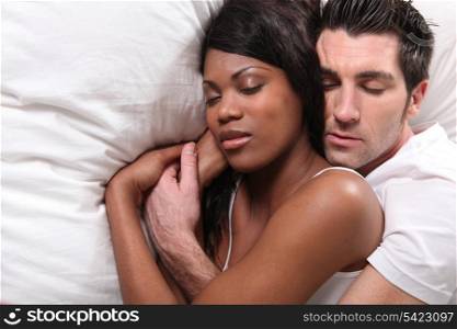 Couple cuddling in bed