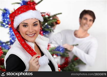 Couple decorating a Christmas tree