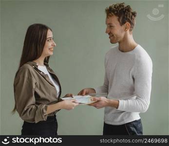couple discussing redecorating house using paint palette