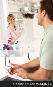 Couple Doing Housework In Kitchen Together