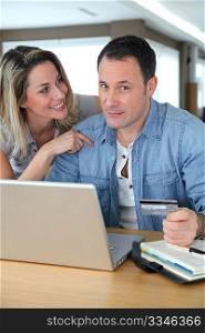 Couple doing online shopping wih laptop computer