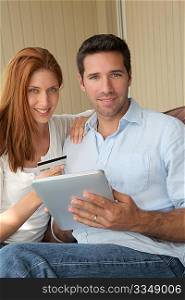 Couple doing online shopping with electronic tablet