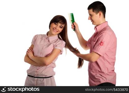 Couple dressed in pink clothes isolated on white. Man comb the Beauty.