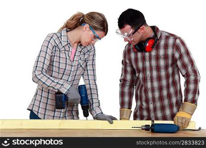 Couple drilling wood