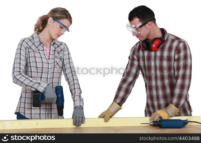 Couple drilling wood