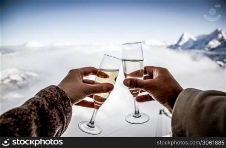 couple drinking champagne and snowy mountains winter holiday