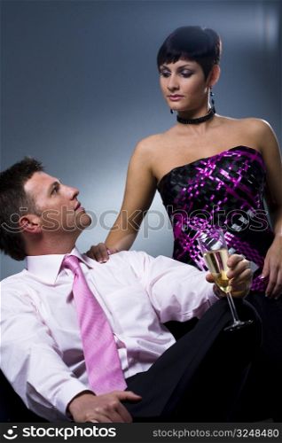 Couple drinking champagne on a party.