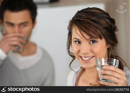 Couple drinking glass of water